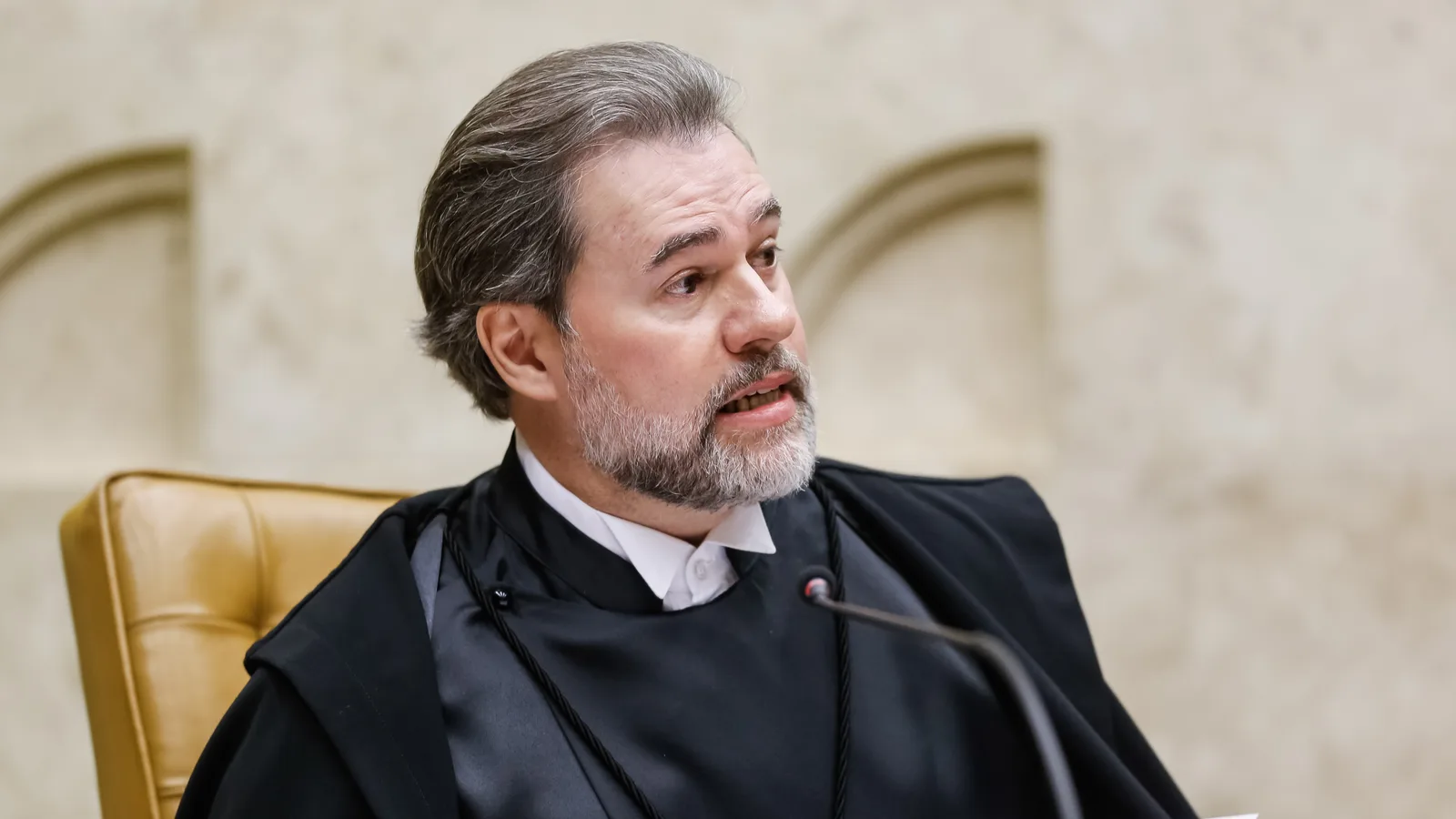 Dias Toffoli de toga, falando ao microfone no plenário do STF